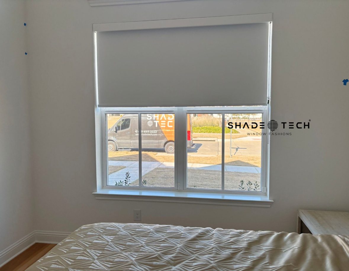 White roller shade in a bedroom window