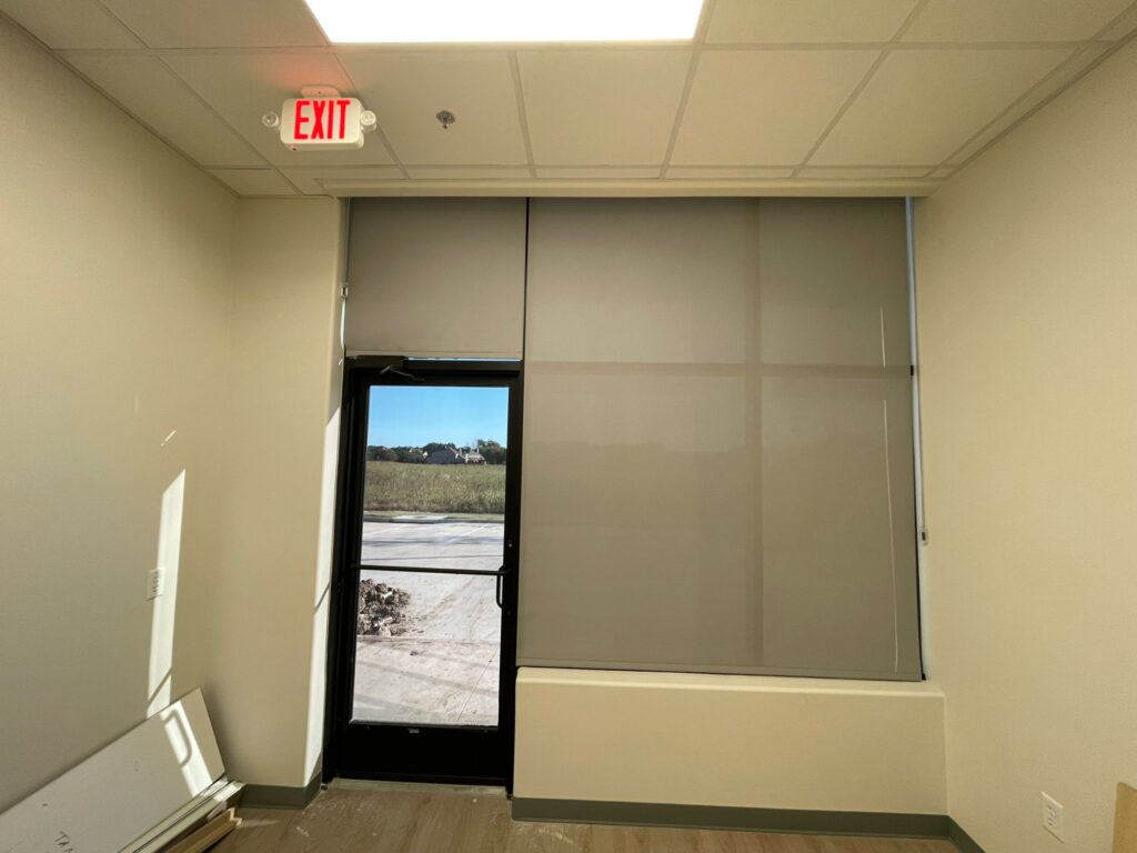 Solar roller shades on a storefront window in a new medical office