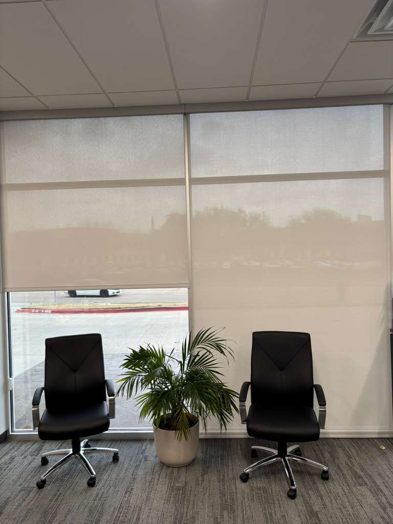 Solar screen roller shades behind office chairs