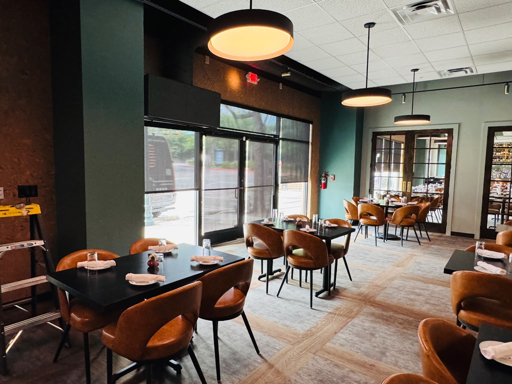 Restaurant dining room with solar roller shades on the front windows