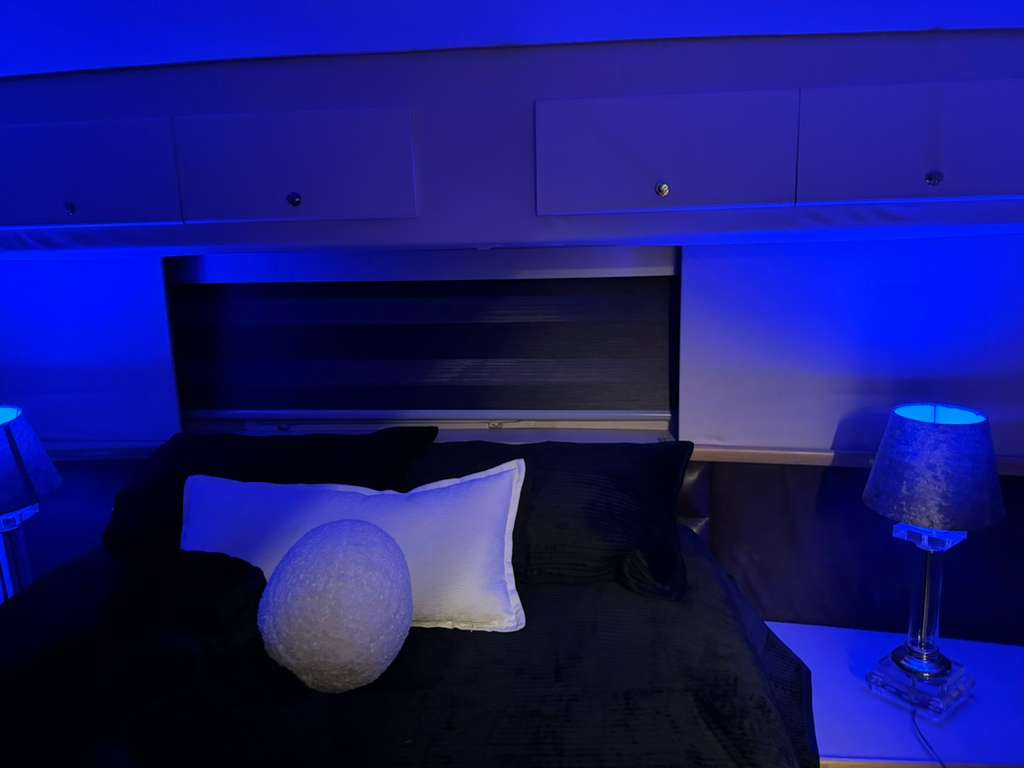 Dark duo shade above the bed in a yacht master cabin