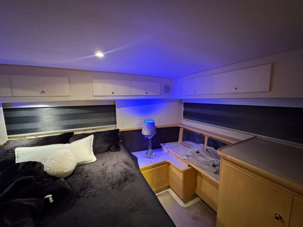 Custom shades on two long cabin windows in a yacht bedroom