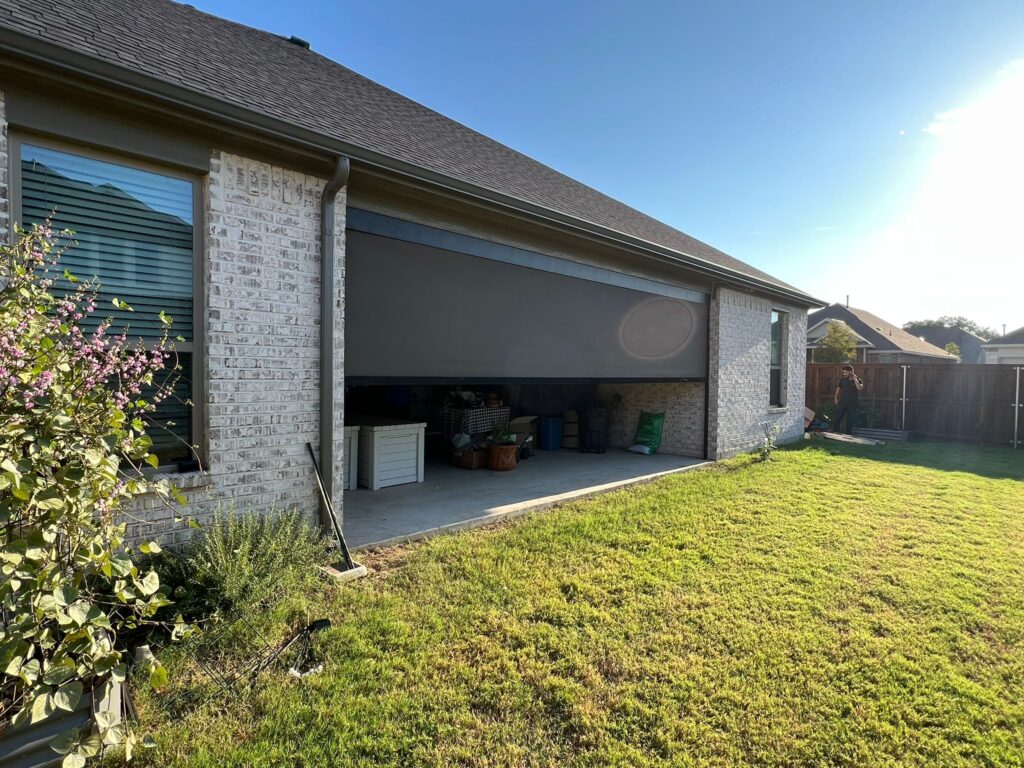 Zip-track screen partly lowered on a long covered patio