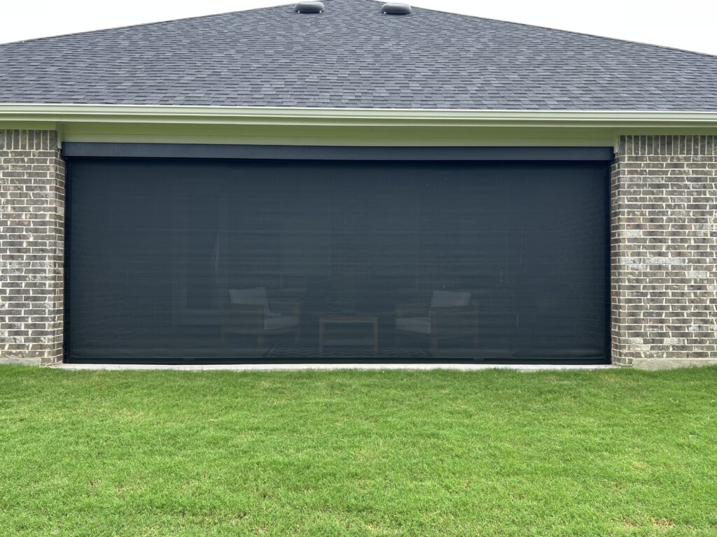 Zip-track screen on a covered patio facing the lawn